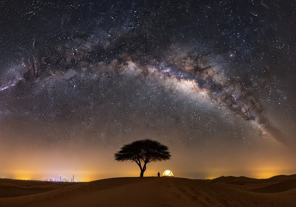 The majestic Milky Way arching over a desert dune during a magical Dubai Stargazing adventure.